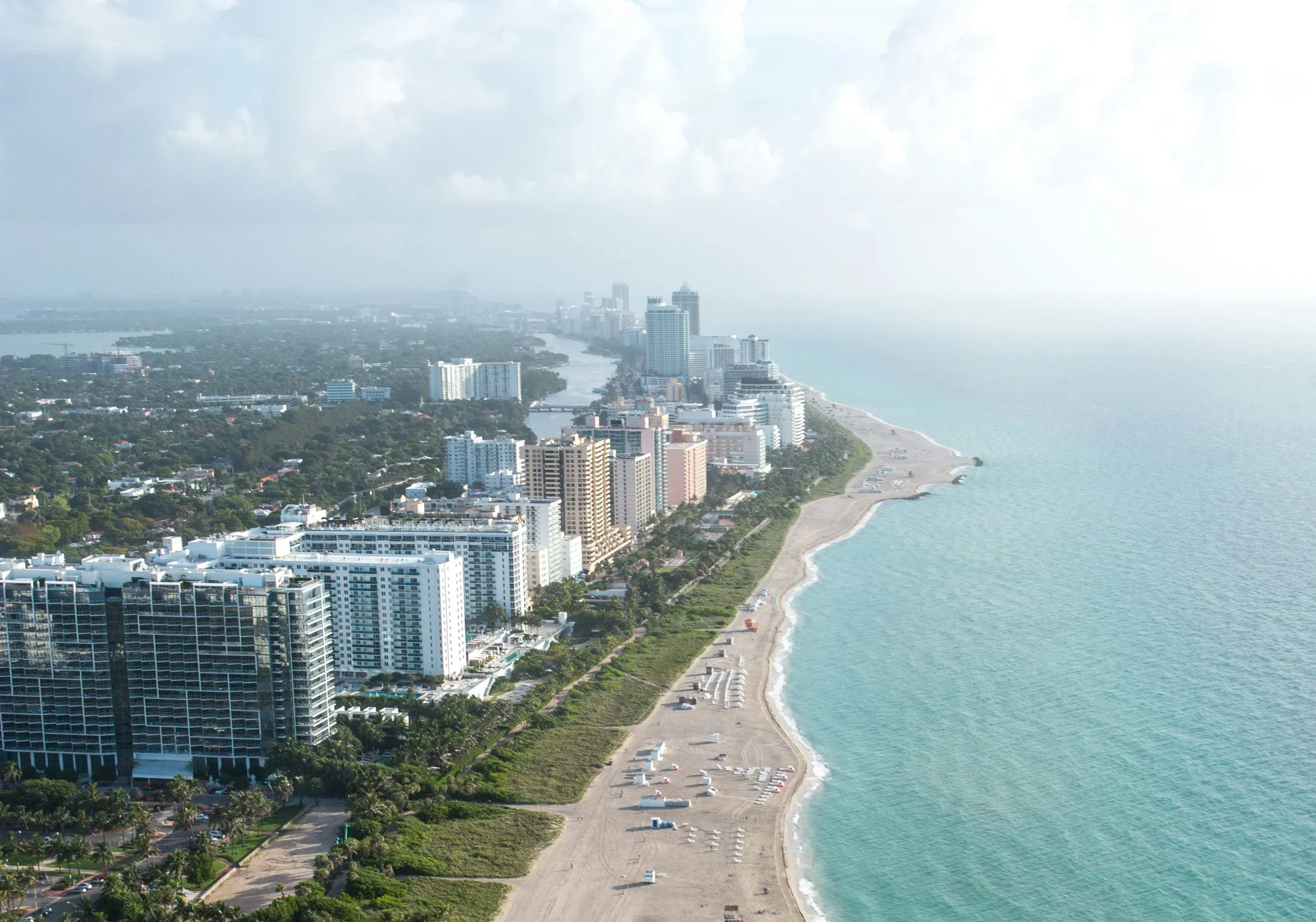 Concrete building facade showing signs of moisture migration and mineral deposit formation